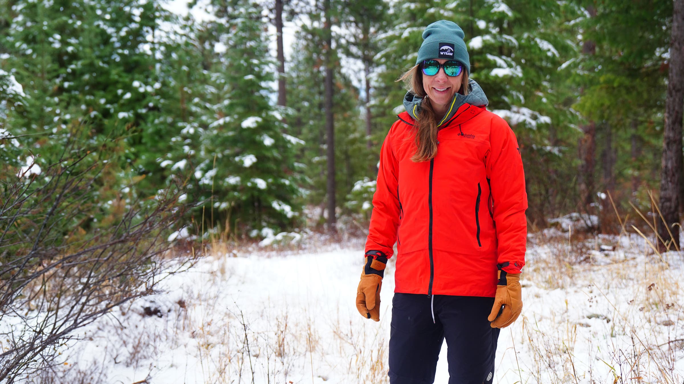 Tester wears Columbia Saudan Pro rain shell in snowy winter forest